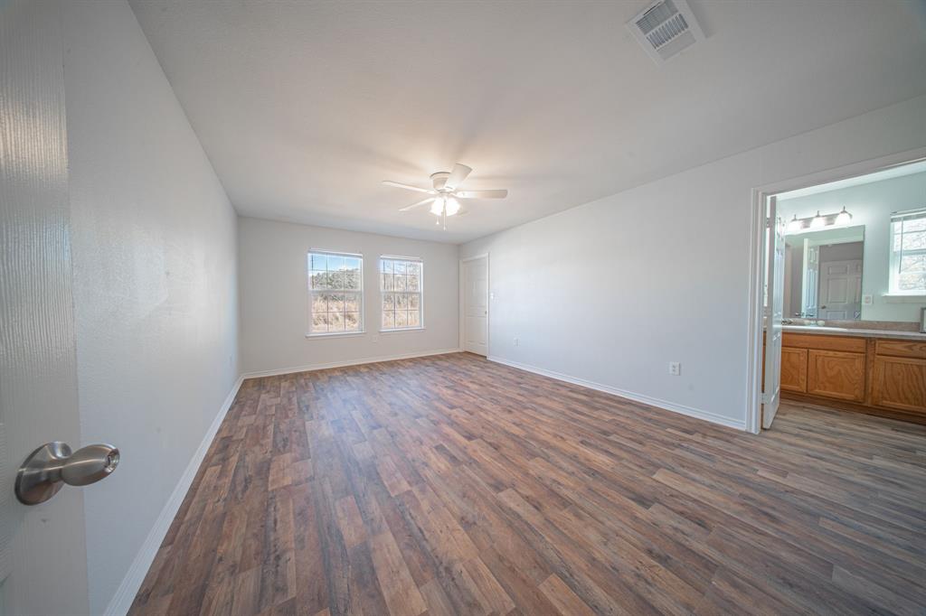 121 Washburn Road North Bells, TX 75414 - Photo 20 of 40 wooden floor in an empty room with a window