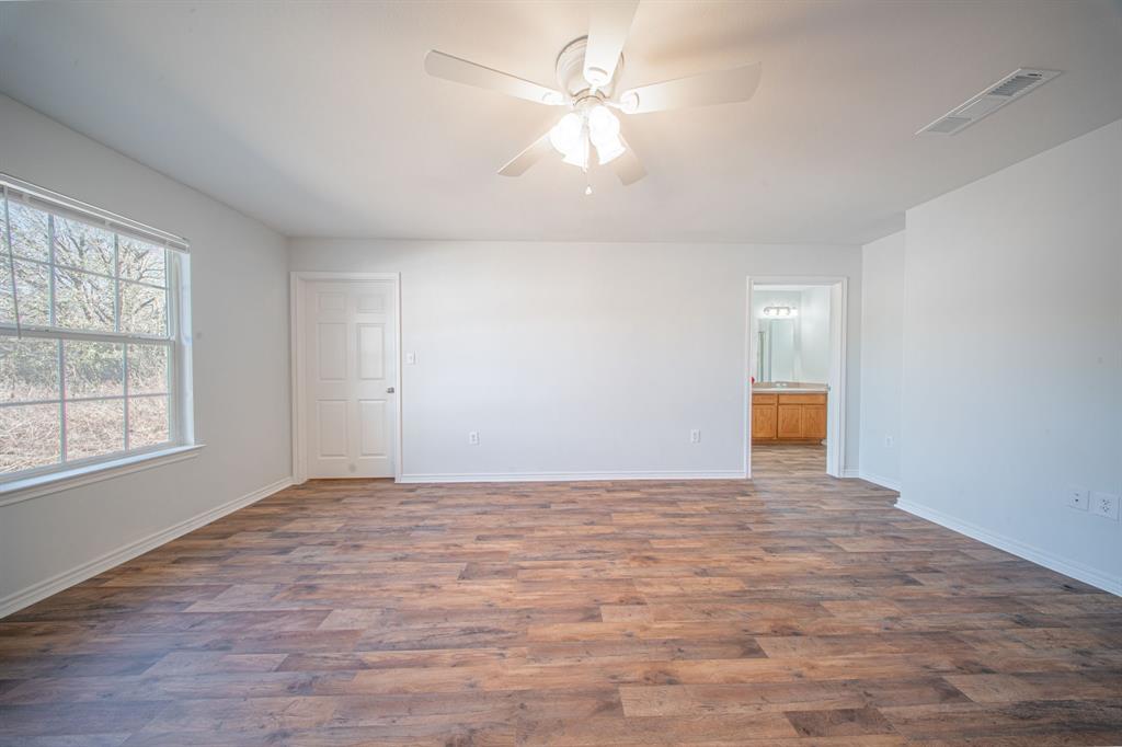 121 Washburn Road North Bells, TX 75414 - Photo 21 of 40 wooden floor in an empty room with a window