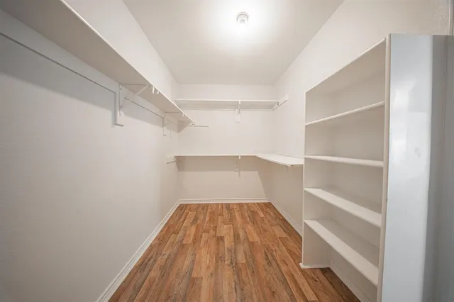 a view of a room with wooden floor