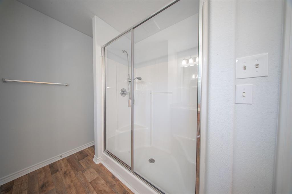 121 Washburn Road North Bells, TX 75414 - Photo 31 of 40 a bathroom with a glass shower door