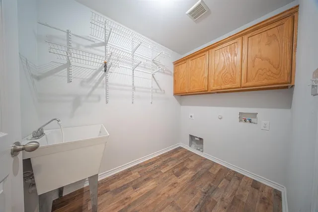 a room with a sink and cabinets