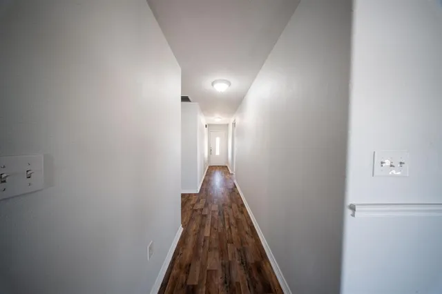 a view of a hallway with a room