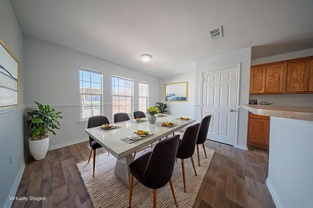 a view of a dining room with furniture window and wooden floor
