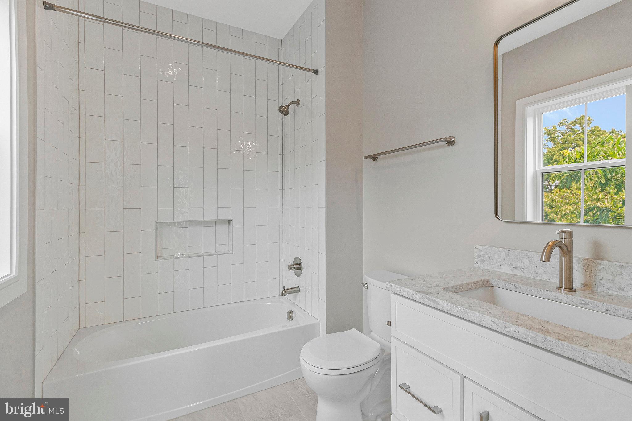 2300 Meridian Street Falls Church, VA 22046 - Photo 37 of 40 a bathroom with a granite countertop sink a toilet and shower