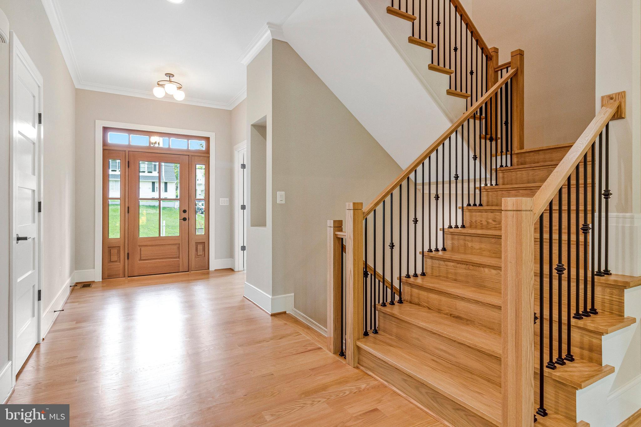 2300 Meridian Street Falls Church, VA 22046 - Photo 6 of 40 a view of an entryway with wooden floor leading to a furnished livingroom and windows