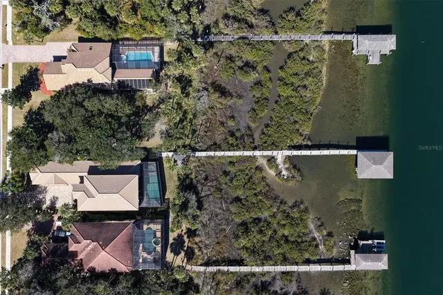 an aerial view of a house with a yard basket ball court and outdoor seating