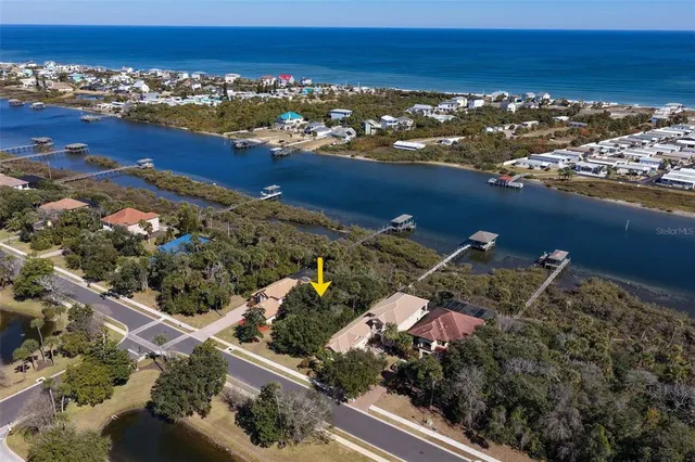 an aerial view of a house with outdoor space swimming pool and ocean view