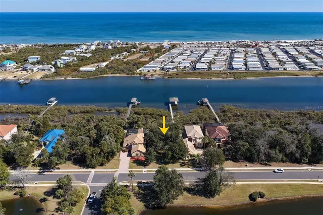 an aerial view of residential houses with outdoor space and swimming pool