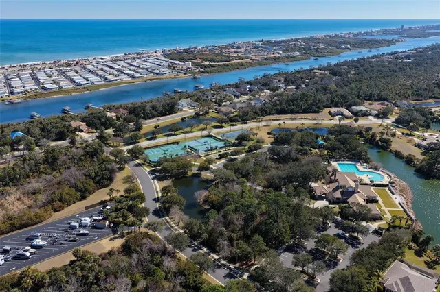 an aerial view of house with yard and ocean view