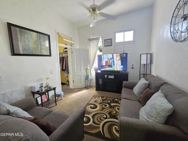 a living room with furniture and a chandelier