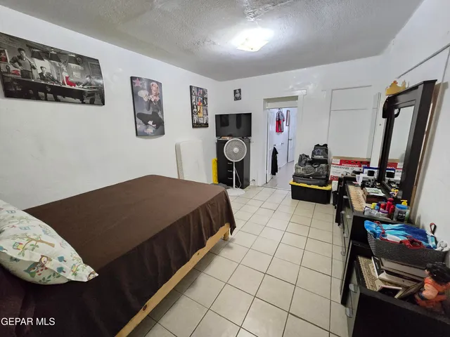 a bed room with a bed and a television