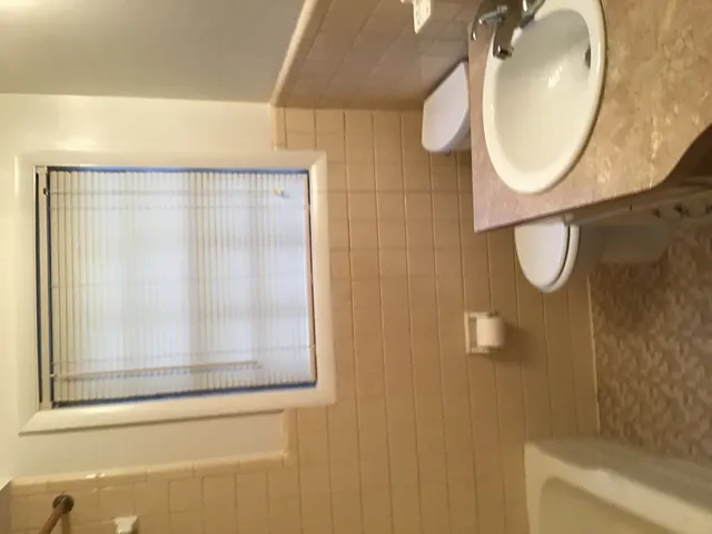 a close view of curtain with a plant