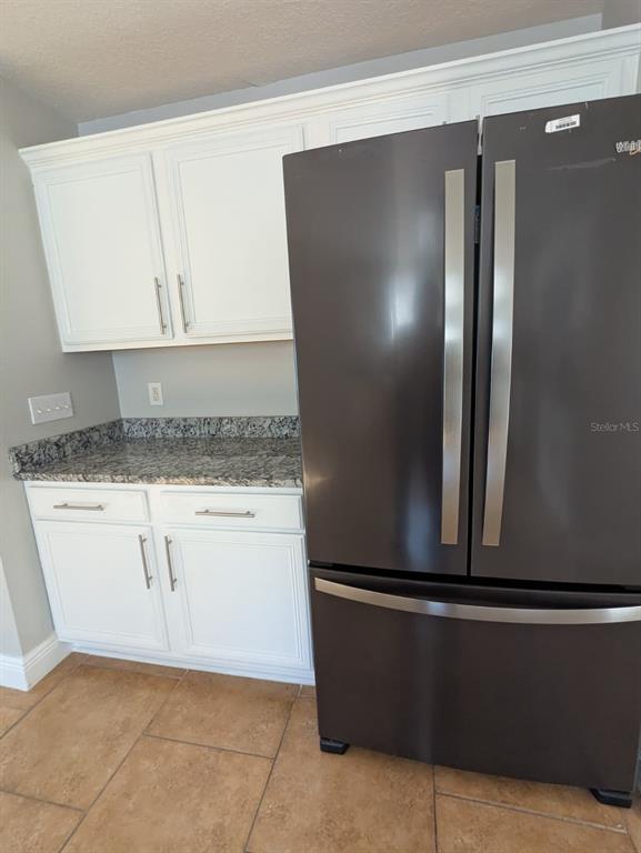 1538 Algonkin Loop Orlando, FL 32828 - Photo 26 of 48 a kitchen with a refrigerator and cabinets
