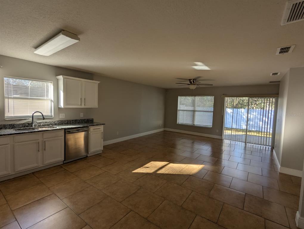 1538 Algonkin Loop Orlando, FL 32828 - Photo 27 of 48 a kitchen with granite countertop a stove a sink and a refrigerator