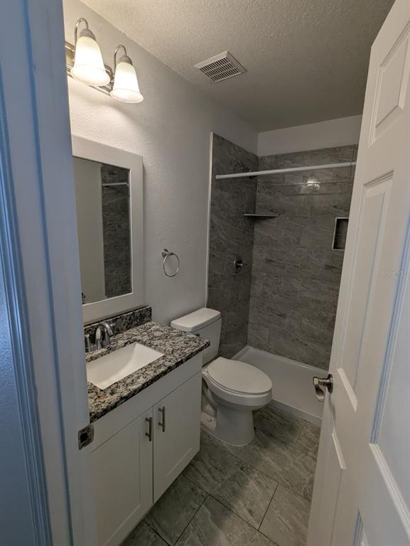 1538 Algonkin Loop Orlando, FL 32828 - Photo 31 of 48 a bathroom with a granite countertop sink toilet and shower