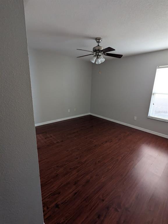 1538 Algonkin Loop Orlando, FL 32828 - Photo 33 of 48 an empty room with wooden floor fan and windows