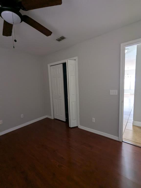1538 Algonkin Loop Orlando, FL 32828 - Photo 34 of 48 an empty room with wooden floor cabinet and windows