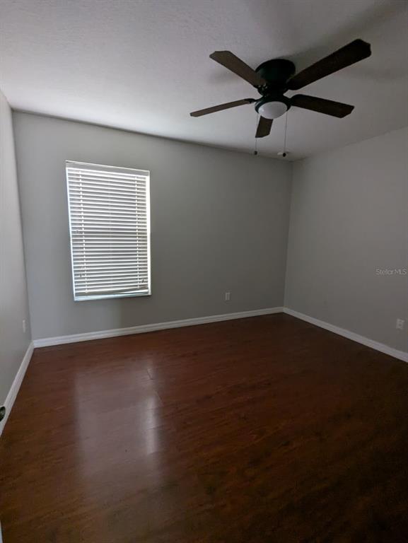1538 Algonkin Loop Orlando, FL 32828 - Photo 35 of 48 an empty room with wooden floor fan and windows