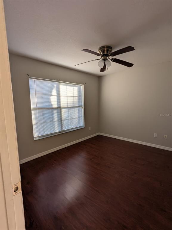 1538 Algonkin Loop Orlando, FL 32828 - Photo 48 of 48 an empty room with wooden floor fan and windows