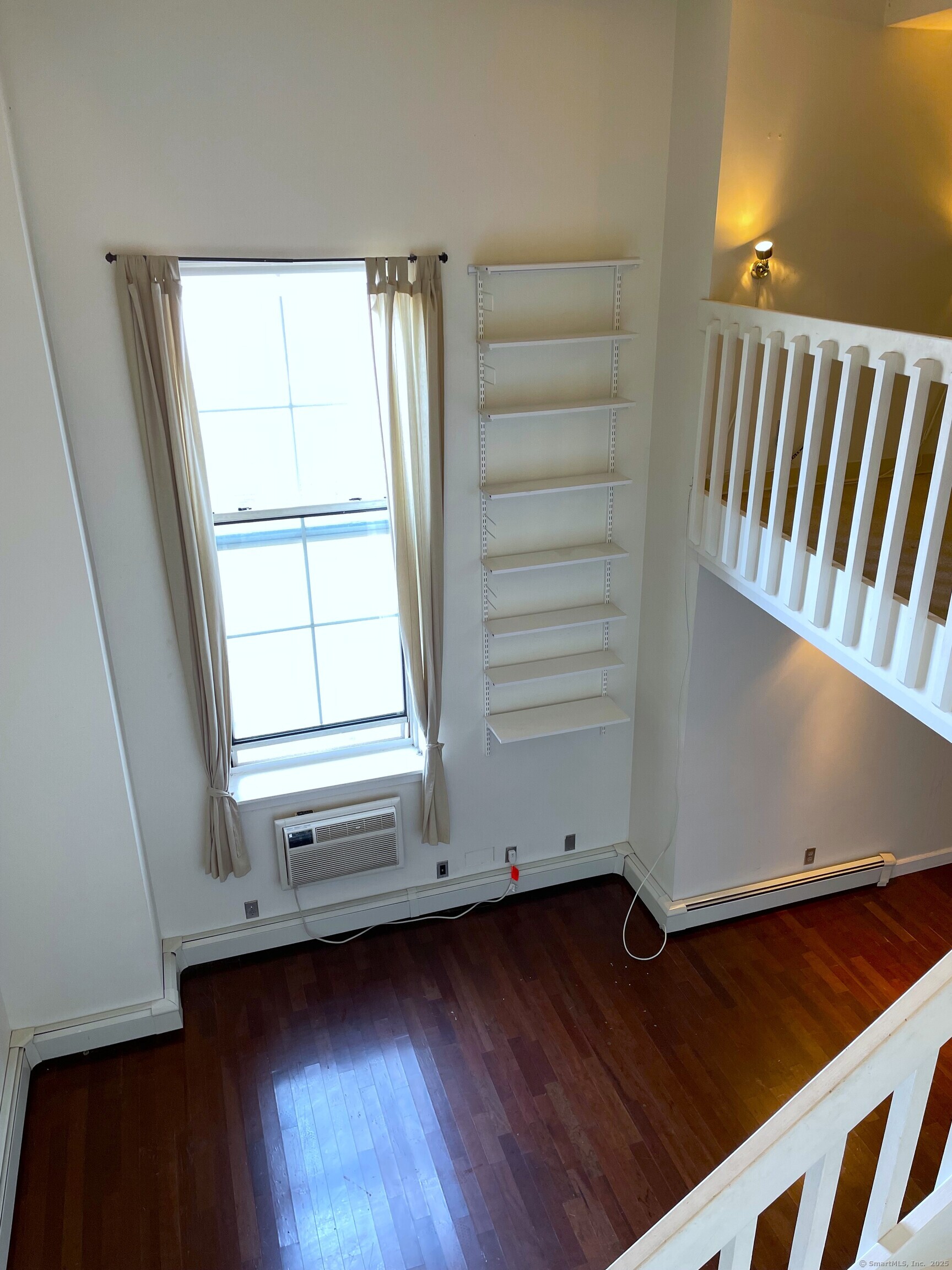 124 Court Street, Unit 502 New Haven, CT 06510 - Photo 2 of 8 an empty room with wooden floor and windows
