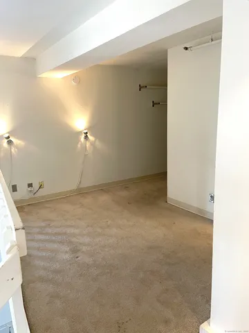 an empty room with wooden floor and window