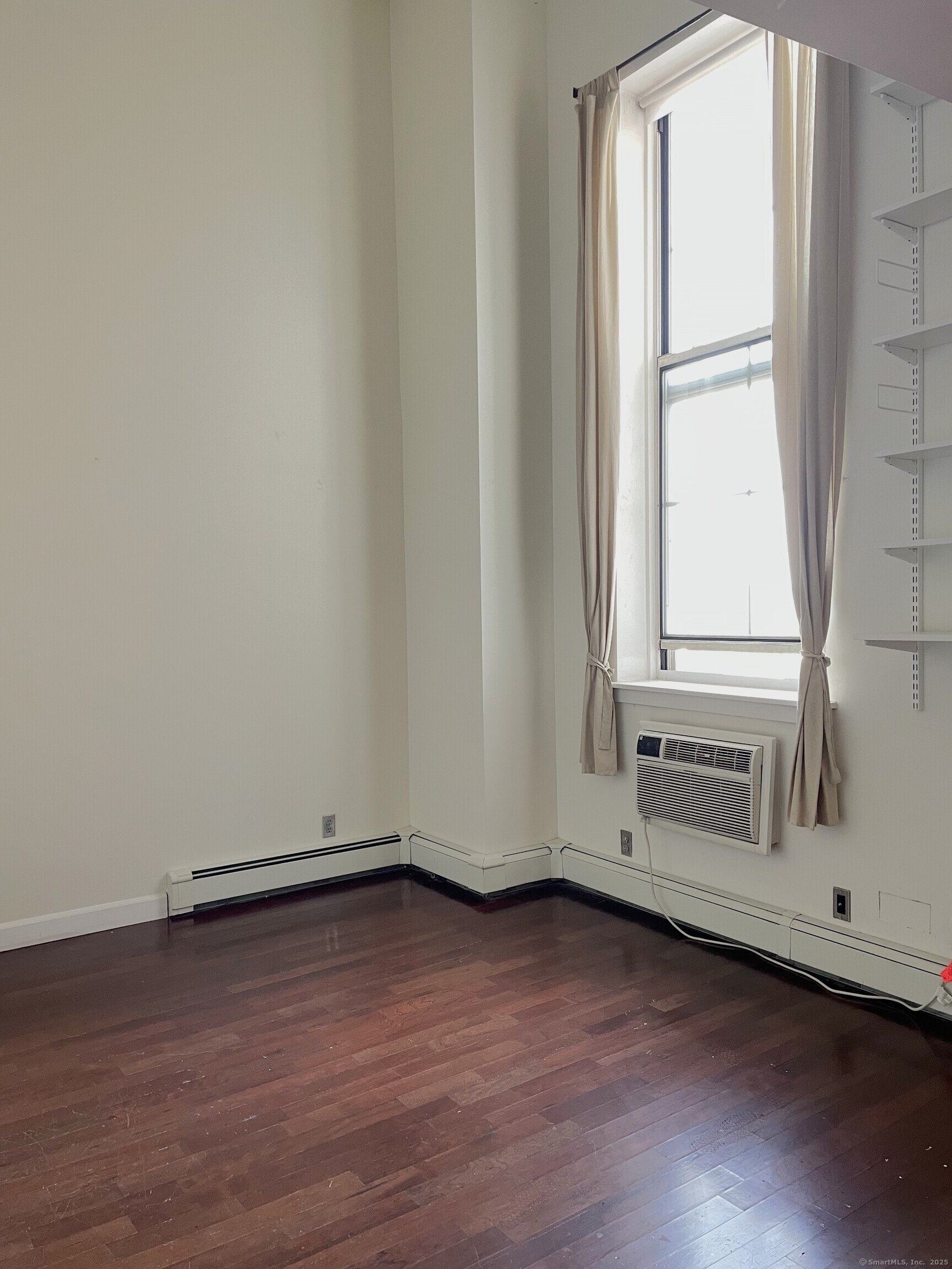 124 Court Street, Unit 502 New Haven, CT 06510 - Photo 8 of 8 an empty room with wooden floor and window