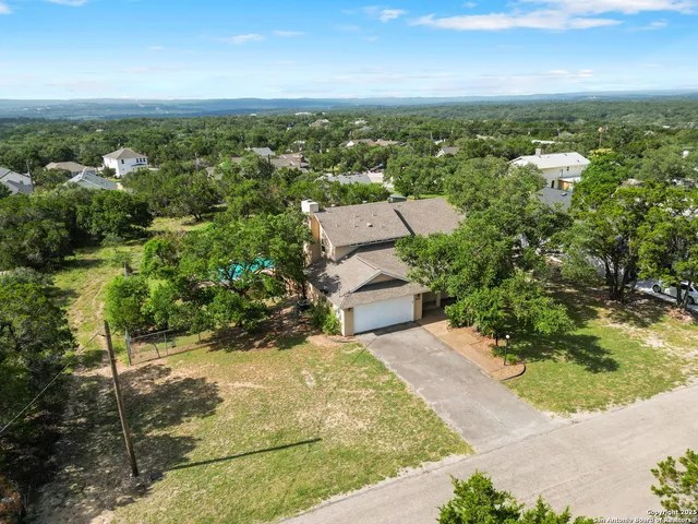 an aerial view of a house with a yard