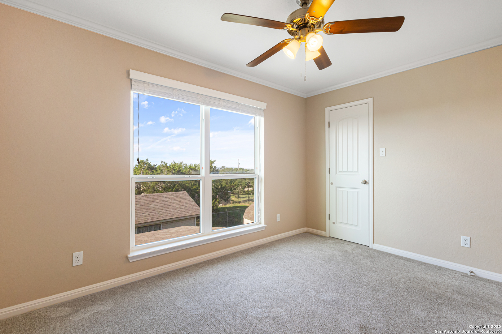 890 Live Oak Drive Spring Branch, TX 78070 - Photo 20 of 49 an empty room with chandelier fan and windows