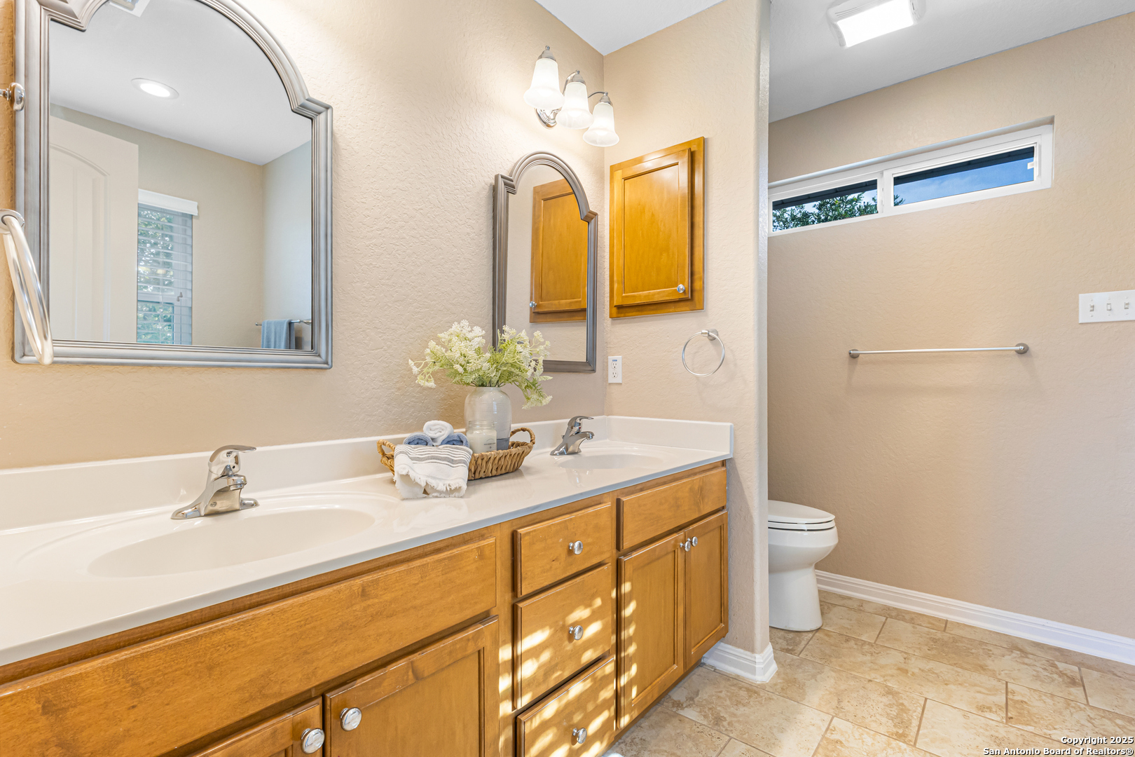 890 Live Oak Drive Spring Branch, TX 78070 - Photo 25 of 49 a bathroom with a double vanity sink toilet and mirror