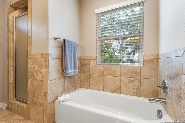 a bathroom with a bathtub and a shower