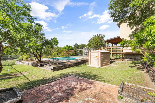 a view of a house with yard and sitting area