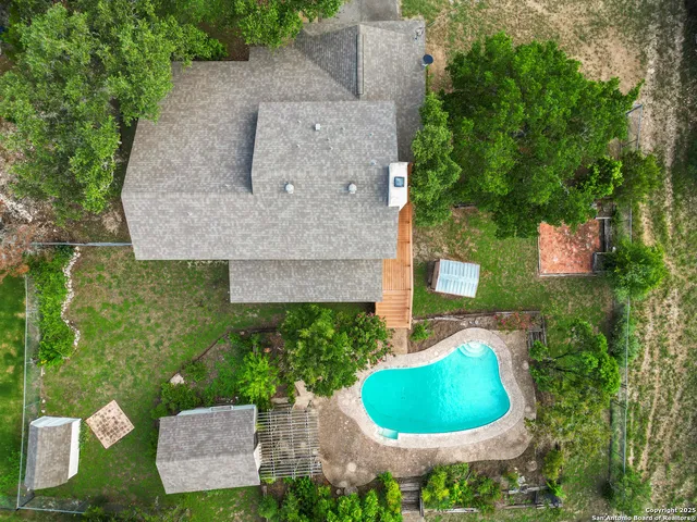 a view of a house with a yard and potted plants