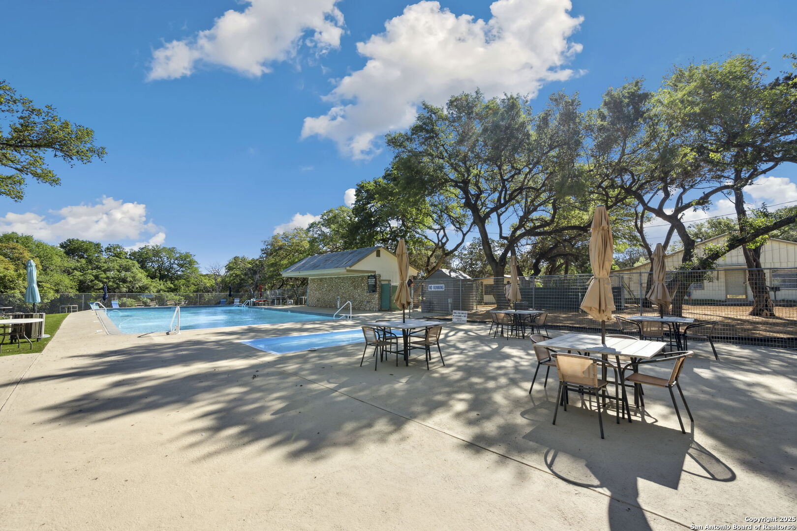 890 Live Oak Drive Spring Branch, TX 78070 - Photo 44 of 49 a row of tables and chairs in a patio
