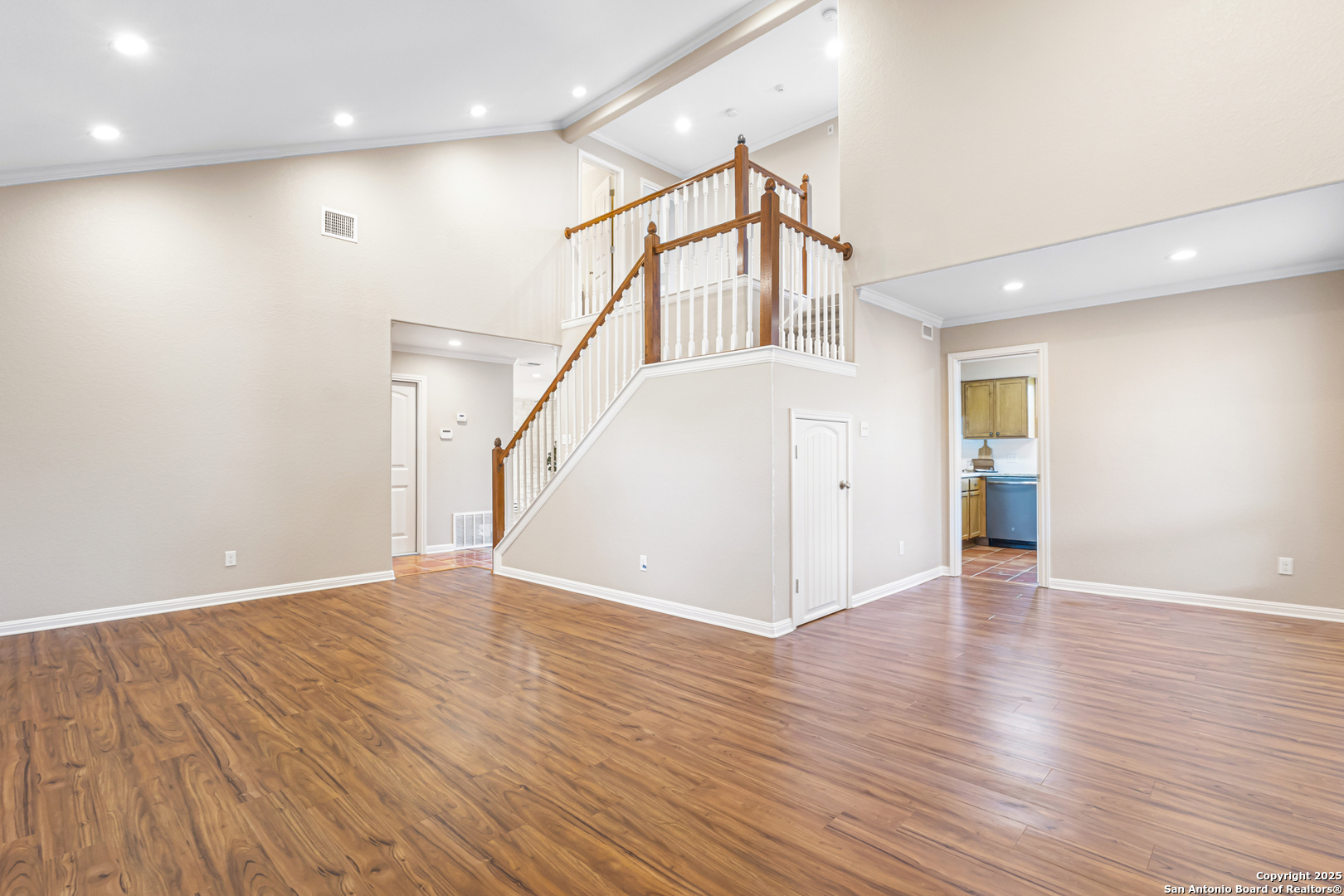 890 Live Oak Drive Spring Branch, TX 78070 - Photo 9 of 49 a view of an empty room with wooden floor and a ceiling fan