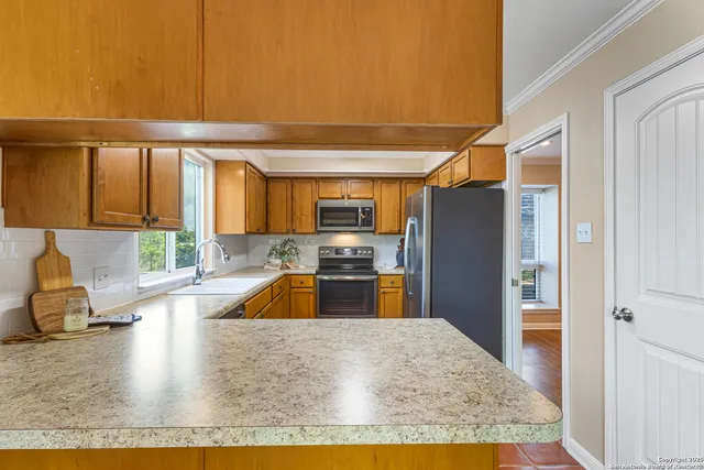 a kitchen with granite countertop a refrigerator and a sink
