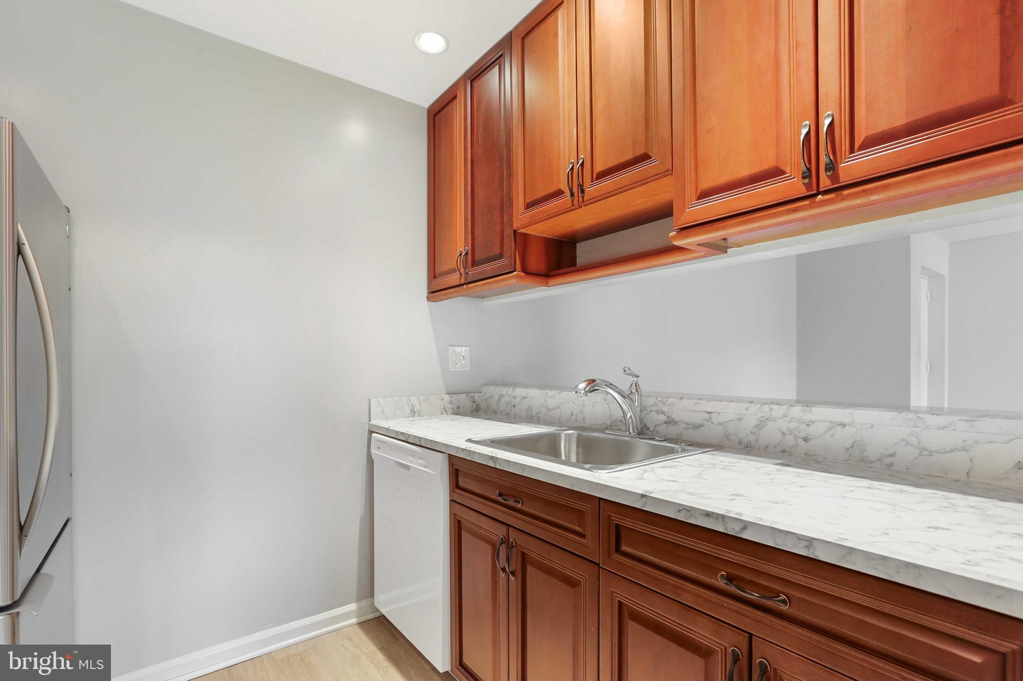 1110 Castle Harbor Way, Unit 3D Glen Burnie, MD 21060 - Photo 11 of 30 a kitchen with a sink and cabinets