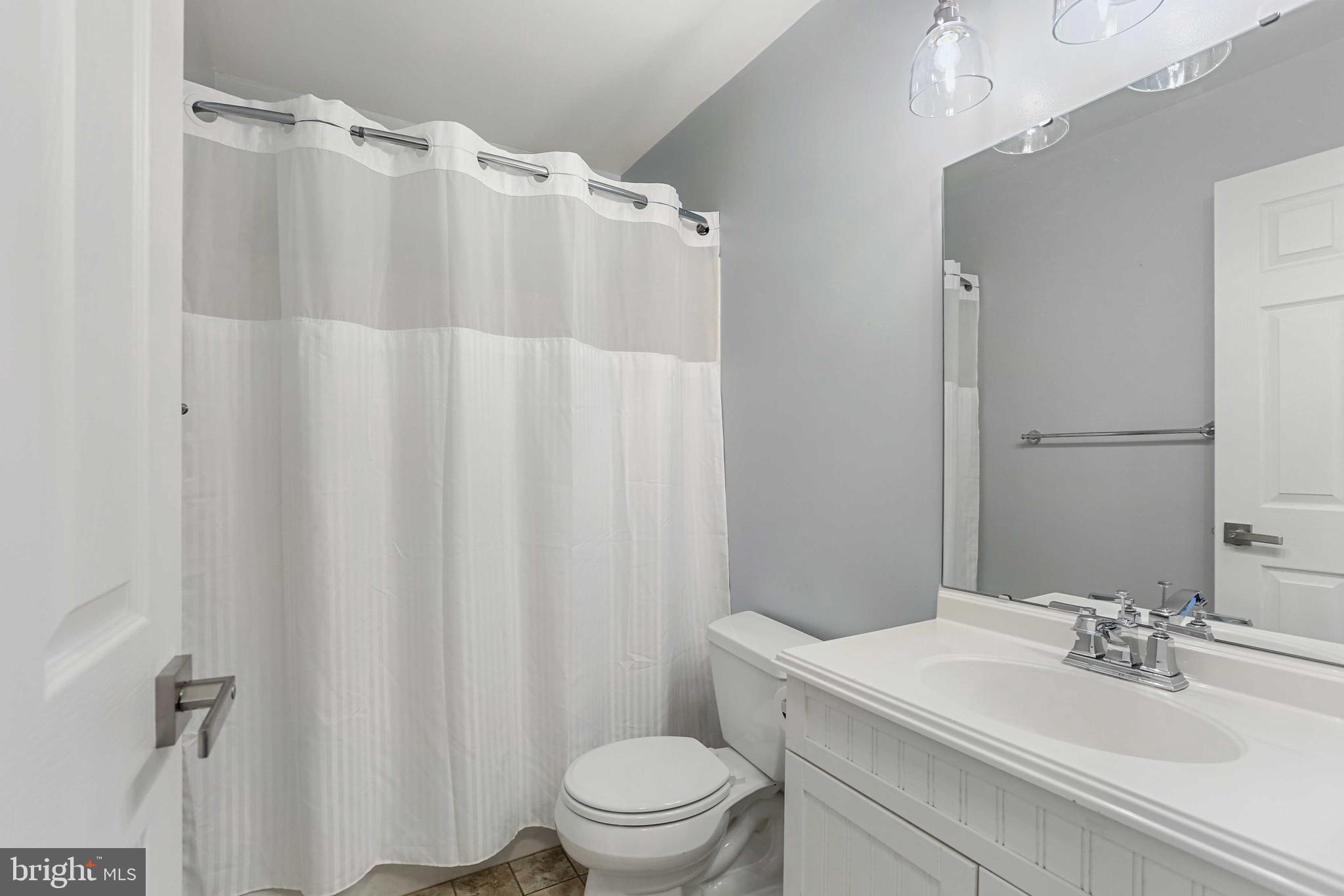 1110 Castle Harbor Way, Unit 3D Glen Burnie, MD 21060 - Photo 17 of 30 a bathroom with a sink a toilet and a mirror