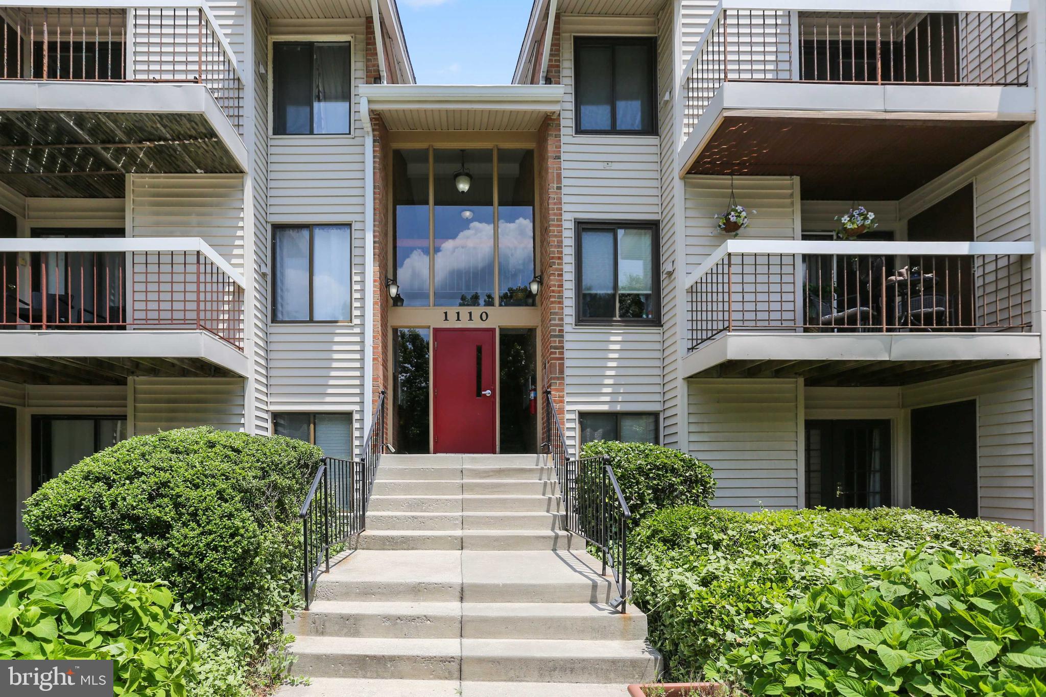 1110 Castle Harbor Way, Unit 3D Glen Burnie, MD 21060 - Photo 2 of 30 a front view of a house with a yard