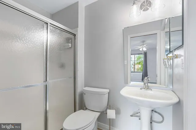 a view of a livingroom with a ceiling fan and window