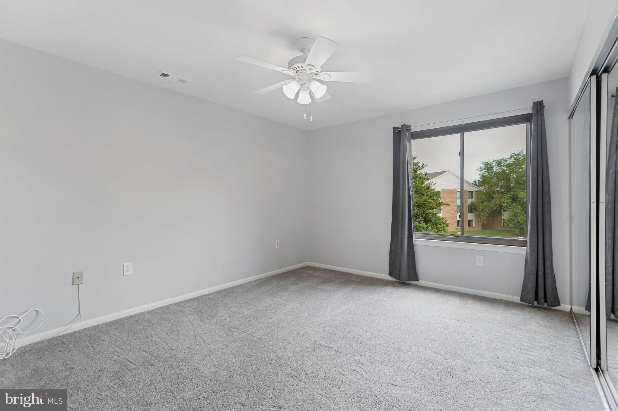 1110 Castle Harbor Way, Unit 3D Glen Burnie, MD 21060 - Photo 23 of 30 a view of a livingroom with a ceiling fan and window