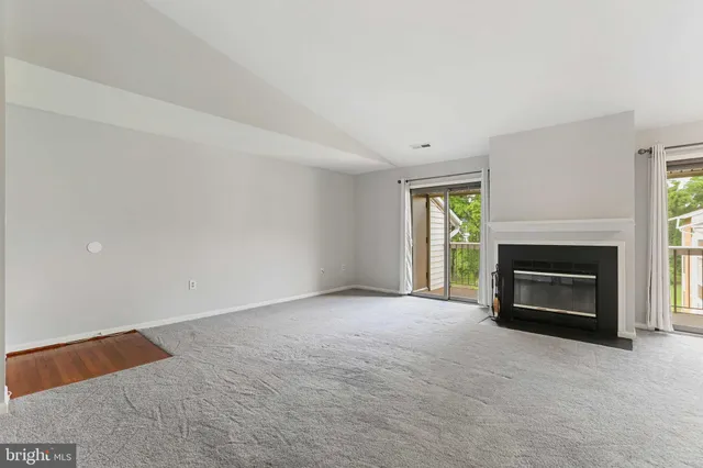 a view of empty room with a fireplace