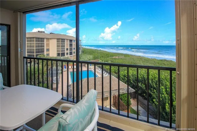 a view of a balcony with lake view and a potted plant