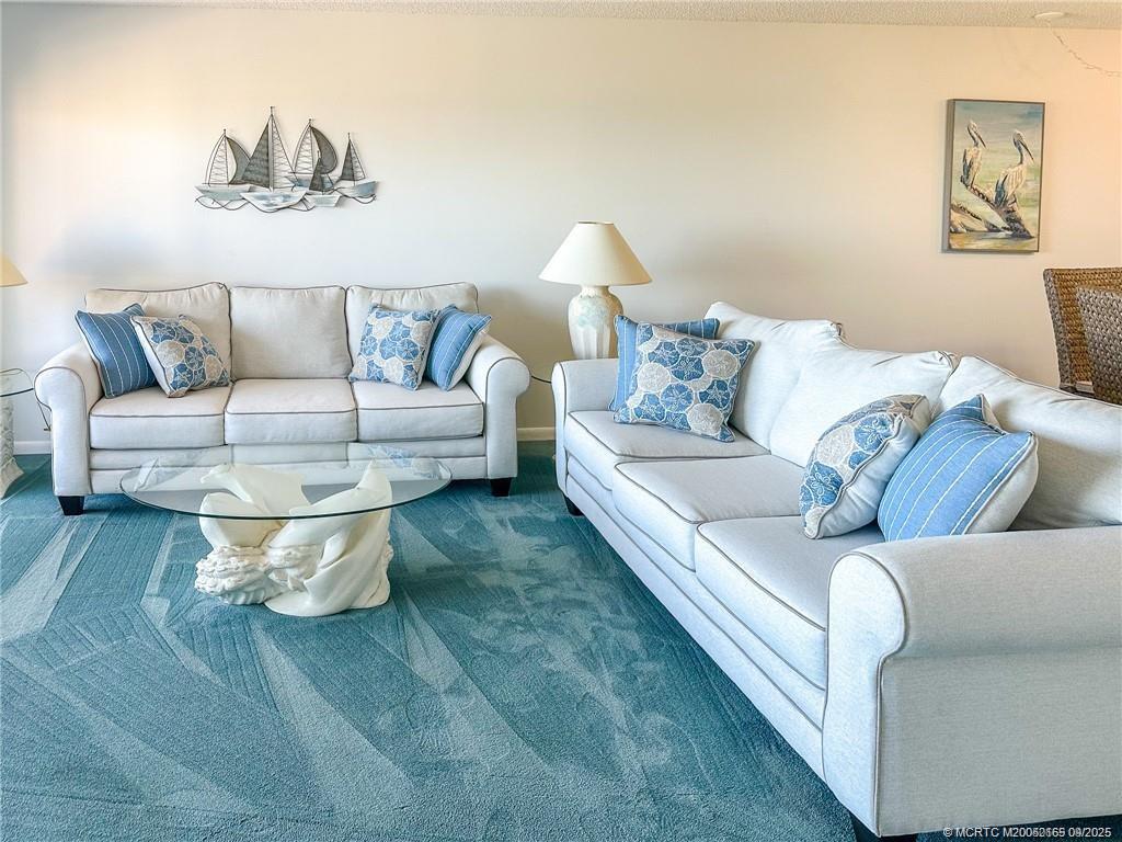 2491 Northeast Ocean Boulevard, Unit 302 Stuart, FL 34996 - Photo 14 of 35 a living room with furniture and a couch