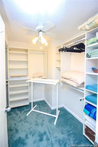 a view of walk in closet and window