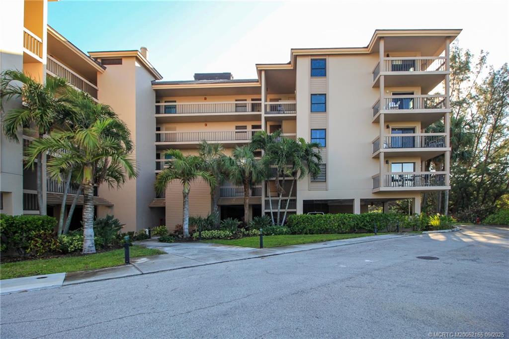 2491 Northeast Ocean Boulevard, Unit 302 Stuart, FL 34996 - Photo 2 of 35 a view of a building with a yard