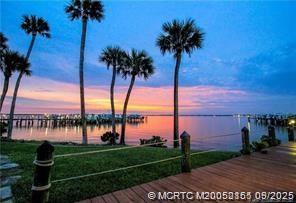 2491 Northeast Ocean Boulevard, Unit 302 Stuart, FL 34996 - Photo 34 of 35 a view of a lake and palm trees