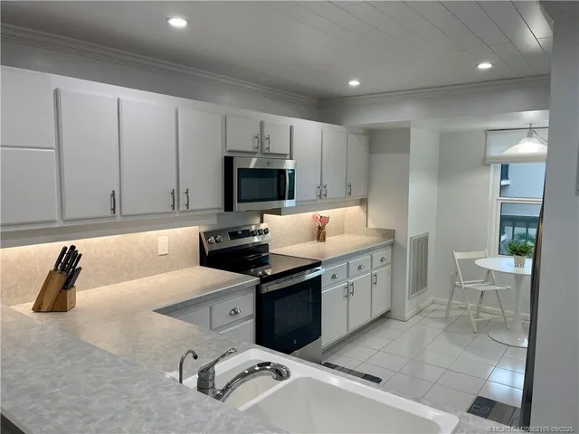 a kitchen with a sink stove and microwave