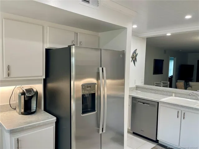 a kitchen with a refrigerator and a sink