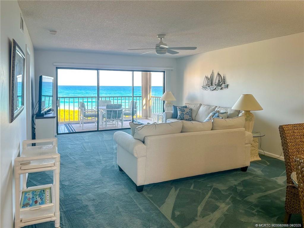2491 Northeast Ocean Boulevard, Unit 302 Stuart, FL 34996 - Photo 9 of 35 a living room with furniture and floor to ceiling windows