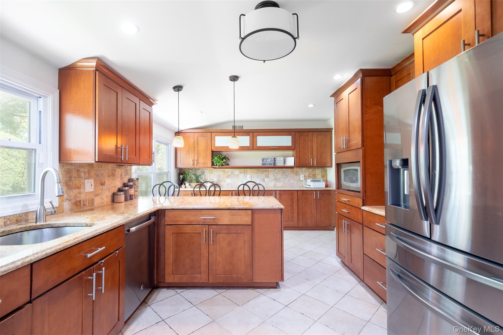 24 Sheldrake Place New Rochelle, NY 10804 - Photo 6 of 26 Kitchen with appliances with stainless steel finishes, a sink, open shelves, brown cabinets, and a peninsula